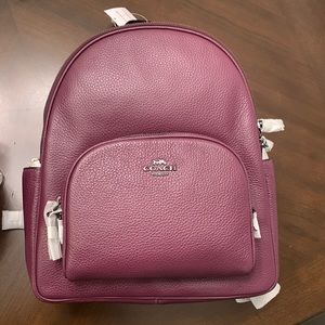 Purple Coach Backpack for traveling.